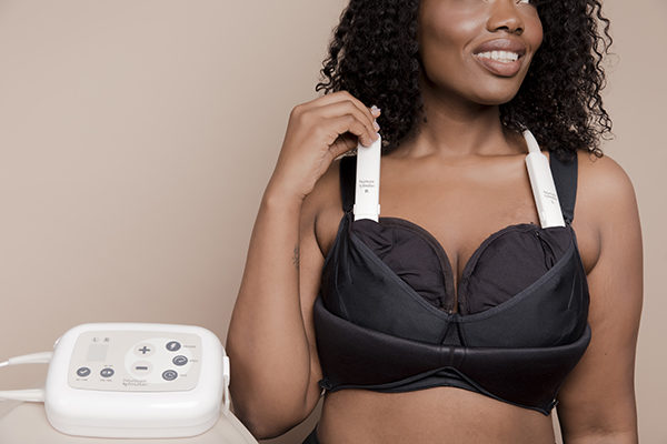 Massage cups attached to pumping bra